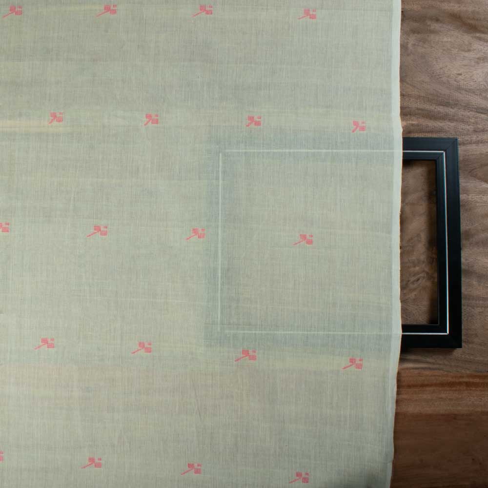 Full-width view of green plain cotton Jamdani fabric with repeating red geometric motif pattern