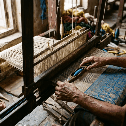 Artisan weaving silk fabric on a traditional handloom in India