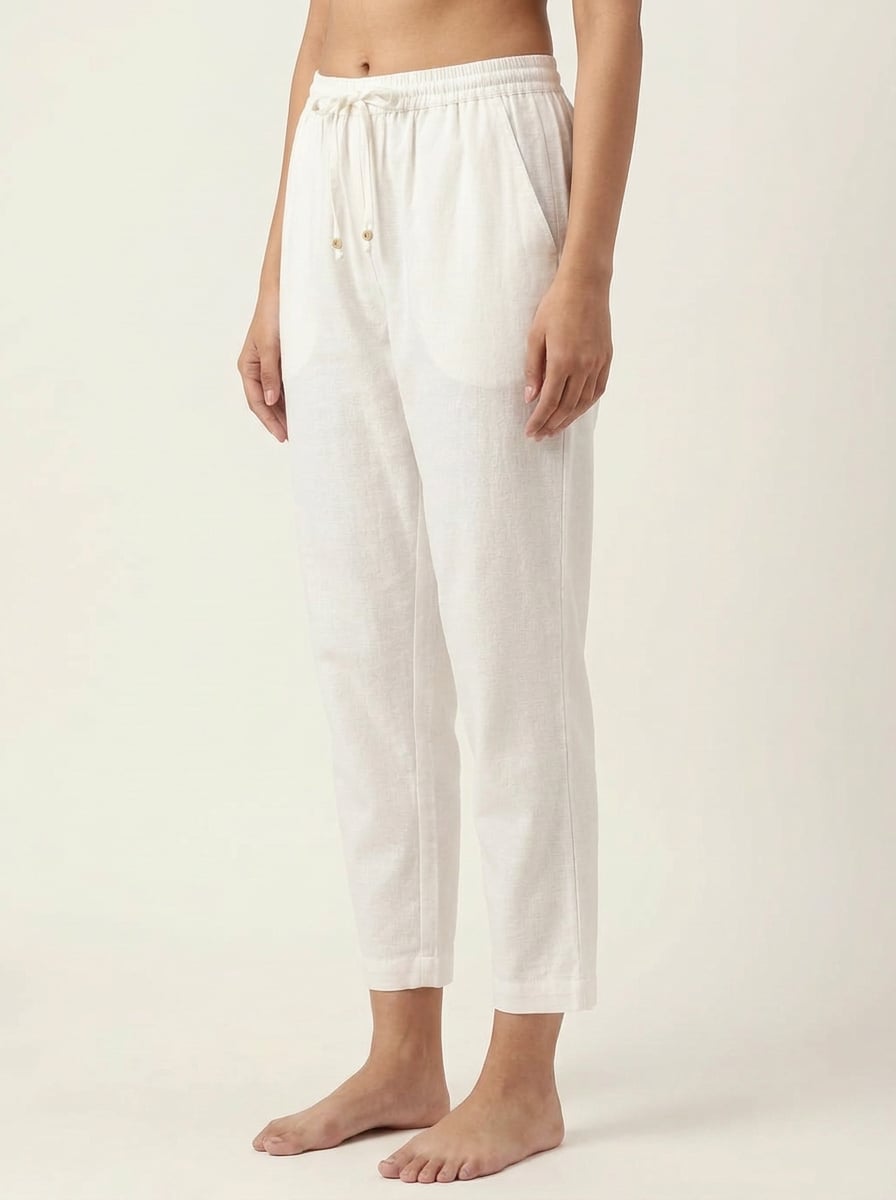 Side view of narrow fit ankle pants with drawstring in handspun and handwoven khadi fabric.