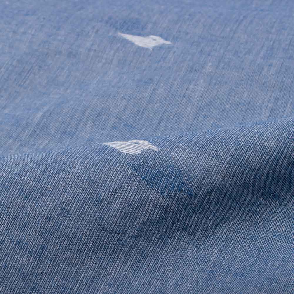 Blue plain cotton Jamdani fabric draped to highlight its soft texture and white arrow motif design